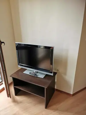 a flat screen tv sitting on top of a wooden table at ICEBERG Ski Apartment No19 in Pamporovo