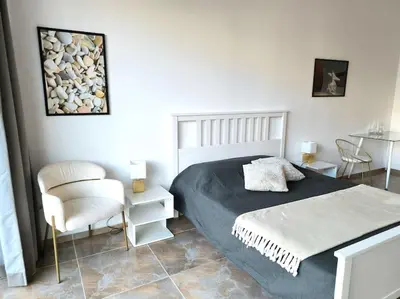 a bedroom with a bed and a chair at My Campus Studios, free parking, self-check in in Sofia
