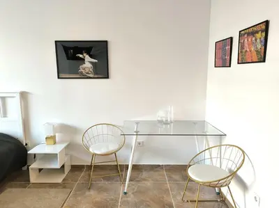 a glass table and two chairs in a living room at My Campus Studios, free parking, self-check in in Sofia