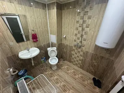 a bathroom with a toilet and a sink at Пандова къща in Sandanski