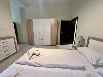 a bedroom with a large white bed and a dresser at Prime Stays at 34 Bratya Miladinovi Street in Sofia