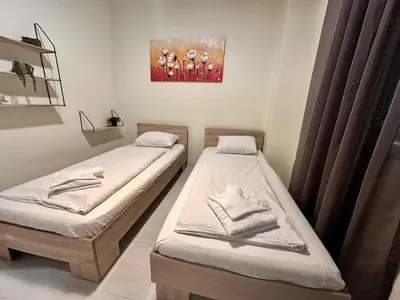 two beds in a room with a painting on the wall at Prime Stays at 34 Bratya Miladinovi Street in Sofia