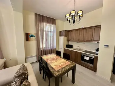 a small kitchen with a table and a couch at Prime Stays at 34 Bratya Miladinovi Street in Sofia