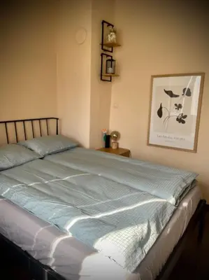 a bedroom with a large bed with blue sheets at Cozy APT Free Parking Wi-Fi Netflix in Sofia