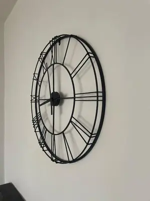 a black and white clock on a white wall at Cozy APT Free Parking Wi-Fi Netflix in Sofia