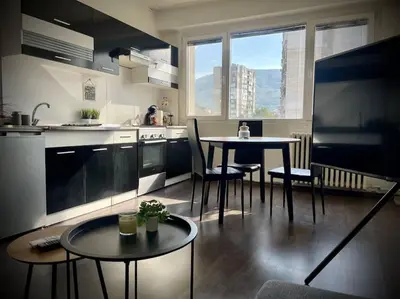 a kitchen with a table and two chairs and a table at Cozy APT Free Parking Wi-Fi Netflix in Sofia