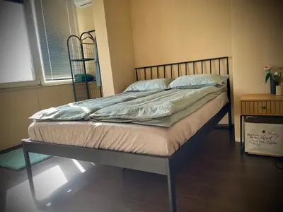 a bed with a metal frame in a bedroom at Cozy APT Free Parking Wi-Fi Netflix in Sofia