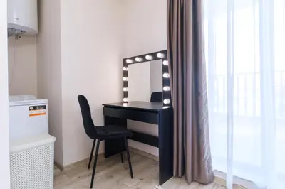 a desk with a mirror and a chair in a room at LDV 13 Apartments Free private parking in Plovdiv