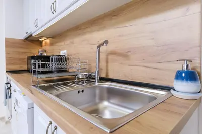 a kitchen with a stainless steel sink in a kitchen at LDV 13 Apartments Free private parking in Plovdiv