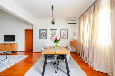 a living room with a table with a vase of flowers at Charming 2BD Apartment in the Heart of the City by Flat Mаnager in Sofia