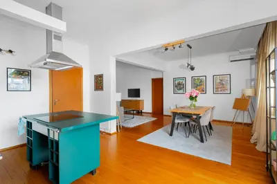 a kitchen and dining room with a blue island and a table at Charming 2BD Apartment in the Heart of the City by Flat Mаnager in Sofia