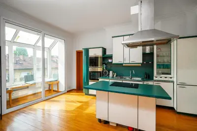 a kitchen with white cabinets and a green counter top at Charming 2BD Apartment in the Heart of the City by Flat Mаnager in Sofia