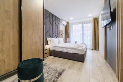 a bedroom with a bed and a large mirror at LDV 13 Residence Free private parking in Plovdiv