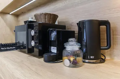 a coffee maker and a jar on a counter at LDV 13 Residence Free private parking in Plovdiv