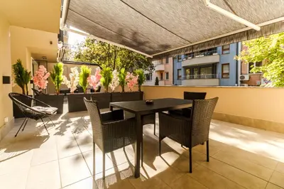 a patio with a table and chairs on a balcony at LDV 13 Residence Free private parking in Plovdiv