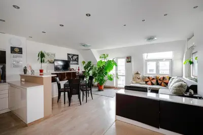 a kitchen and living room with a couch and a table at Spacious 2BD Flat with Secure Free Parking by Flat Mаnager in Sofia