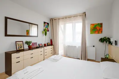 a bedroom with a large white bed and a window at Spacious 2BD Flat with Secure Free Parking by Flat Mаnager in Sofia