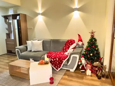 a living room with a christmas tree and a couch at Snow White - Luxury Stay with free Bottle of Wine in Bansko