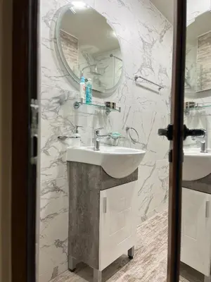 a bathroom with a sink and a mirror at Snow White - Luxury Stay with free Bottle of Wine in Bansko