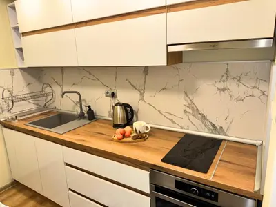 a kitchen with white cabinets and a counter top at Snow White - Luxury Stay with free Bottle of Wine in Bansko