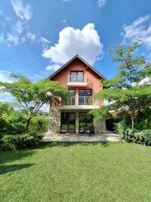an exterior view of a house with a large yard at Guest House Vessyta in Sapareva Banya