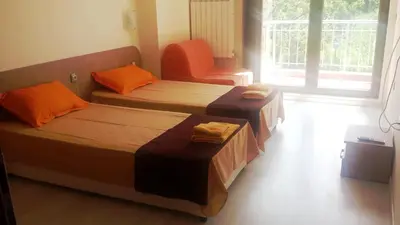 two beds sitting in a room with a window at Guest House Vessyta in Sapareva Banya