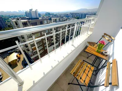 a balcony with a table and chairs on a building at Best View Studio in Sofia