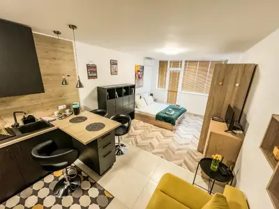 a living room with a desk and a bedroom at Best View Studio in Sofia