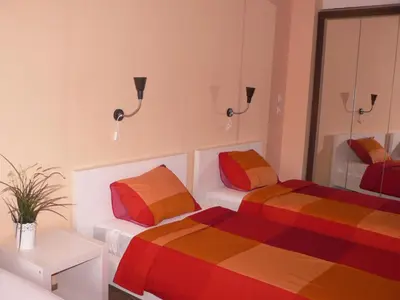 a room with two beds and a mirror at Stay Nexus Galaxy Center in Sofia