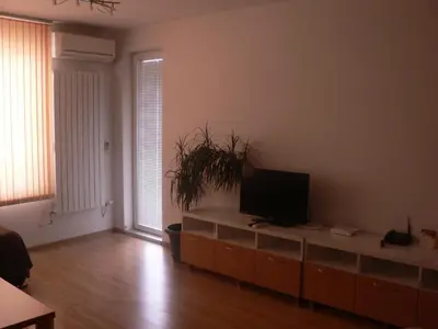 a living room with a flat screen tv on a cabinet at Stay Nexus Galaxy Center in Sofia
