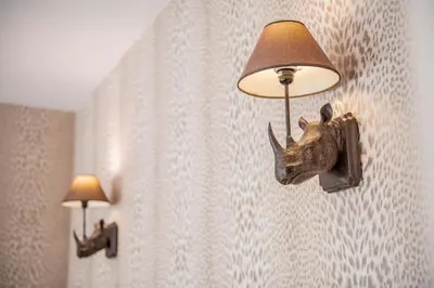 a lamp with a rhino head on a wall at Villa 1331 in Zheleznitsa