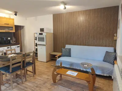 a living room with a blue couch and a table at Only You Boutique Apartment in Sofia