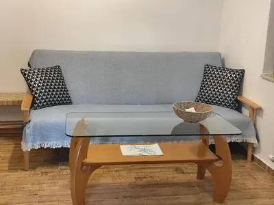 a living room with a couch and a table at Only You Boutique Apartment in Sofia