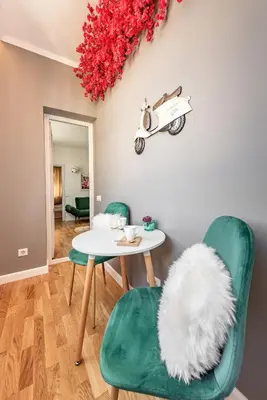 a dining room with a table and a motorcycle on the wall at Vespa Home Boutique Apartment in Sofia