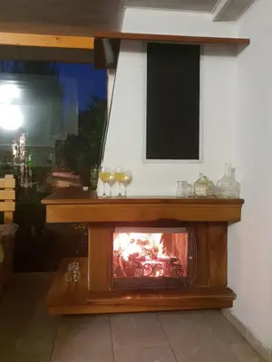 a fireplace in the corner of a room at Kyurkchievi Guest House in Sapareva Banya