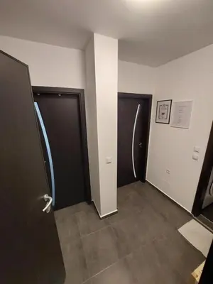 a hallway with two doors and a tile floor at Sky Hills 2 Apartment in Sandanski