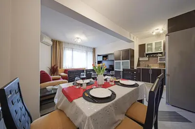 a kitchen and dining room with a table and chairs at SouthPark Luxe - Free Underground Parking - Metro in Sofia