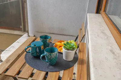 a table with three coffee cups and oranges on it at SouthPark Luxe - Free Underground Parking - Metro in Sofia
