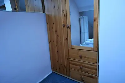 a closet with a mirror and a wooden cabinet at National Theatre Loft in Sofia