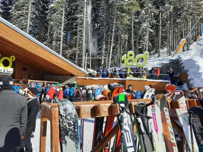 a group of people standing at a ski lodge with skis at Apartment in Aspen Golf in Bansko