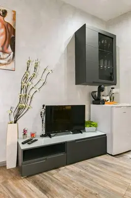 a living room with a tv on a table at Velar 1BDR Apartment in Sofia