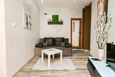 a living room with a couch and a table at Velar 1BDR Apartment in Sofia
