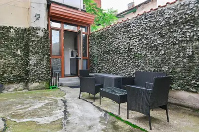 a group of chairs and a table in front of a building at Velar 1BDR Apartment in Sofia