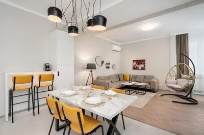 a dining room and living room with a table and chairs at Top Centre Bright & Sunny Stylish Apt with 2BDR and 2BTH in Sofia
