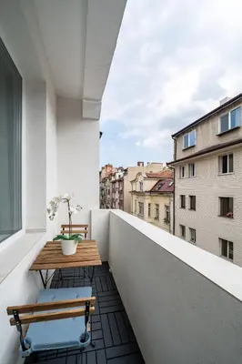 a balcony with a wooden table and a bench at Top Centre Bright & Sunny Stylish Apt with 2BDR and 2BTH in Sofia