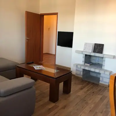 a living room with a coffee table and a fireplace at Spacious 2 Bed Apartment Close To Gondola in Bansko