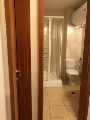 a bathroom with a toilet and a glass shower at Spacious 2 Bed Apartment Close To Gondola in Bansko