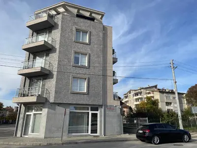 a building with a car parked in front of it at Апартамент Димана in Hisarya