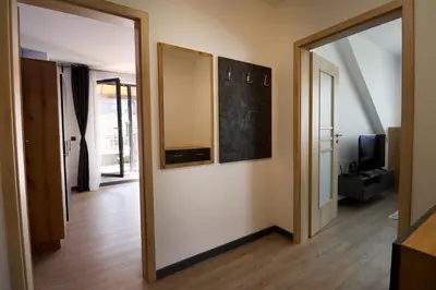 a hallway with a mirror and a door with a television at New Sofia Sunset 1BDRM, Free Parking and Terrace in Sofia