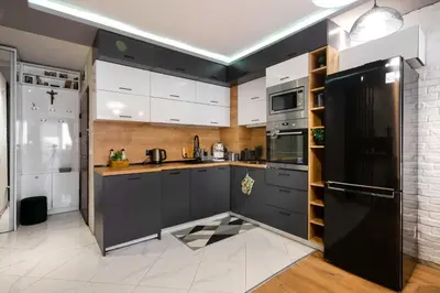 a kitchen with black cabinets and a black refrigerator at Feel Right at Home - Bright and Modern Apartment by Flat Mаnager in Sofia